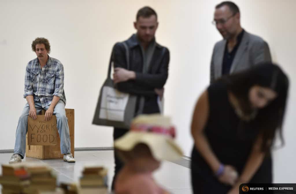 A sculpture entitled 'Homeless Person' (L) by the late U.S. artist Duane Hanson is exhibited at the Serpentine Sackler Gallery in London, June 1, 2015. Hanson's lifelike sculptures portraying working-class Americans and overlooked members of society are being brought together in the largest show of his work in Britain since 1997. REUTERS/Toby Melville